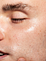Close-up of a man applying face to his skin