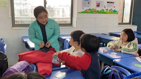 Ashley helps the children decorate their holiday cards for their parents and teachers using Latin letter writing conventions and phrases.