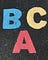 Letras BCA escritas em concreto