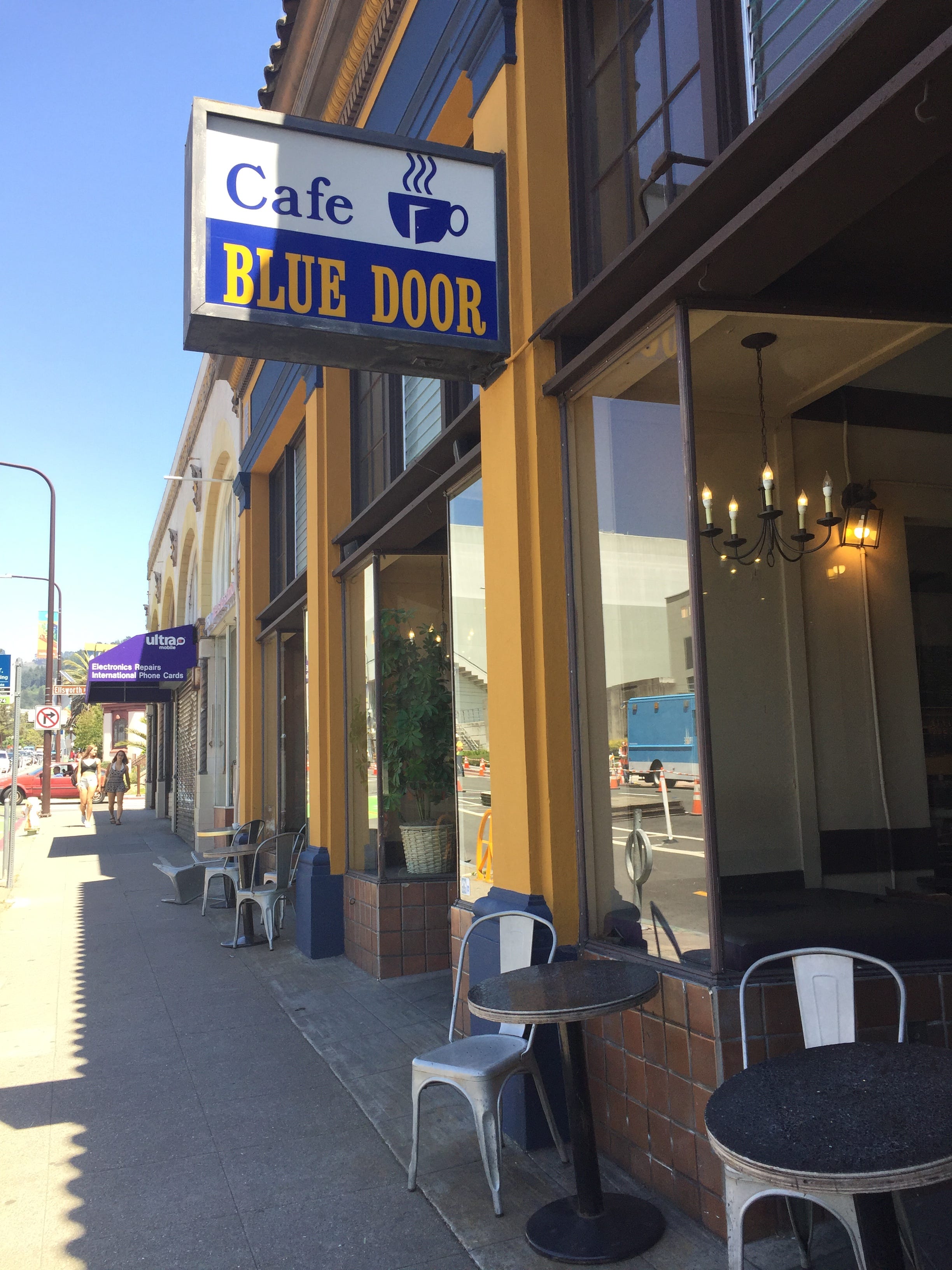 A Coffee Lover Shops And Meets Acquaintances At Cafe Blue Door A