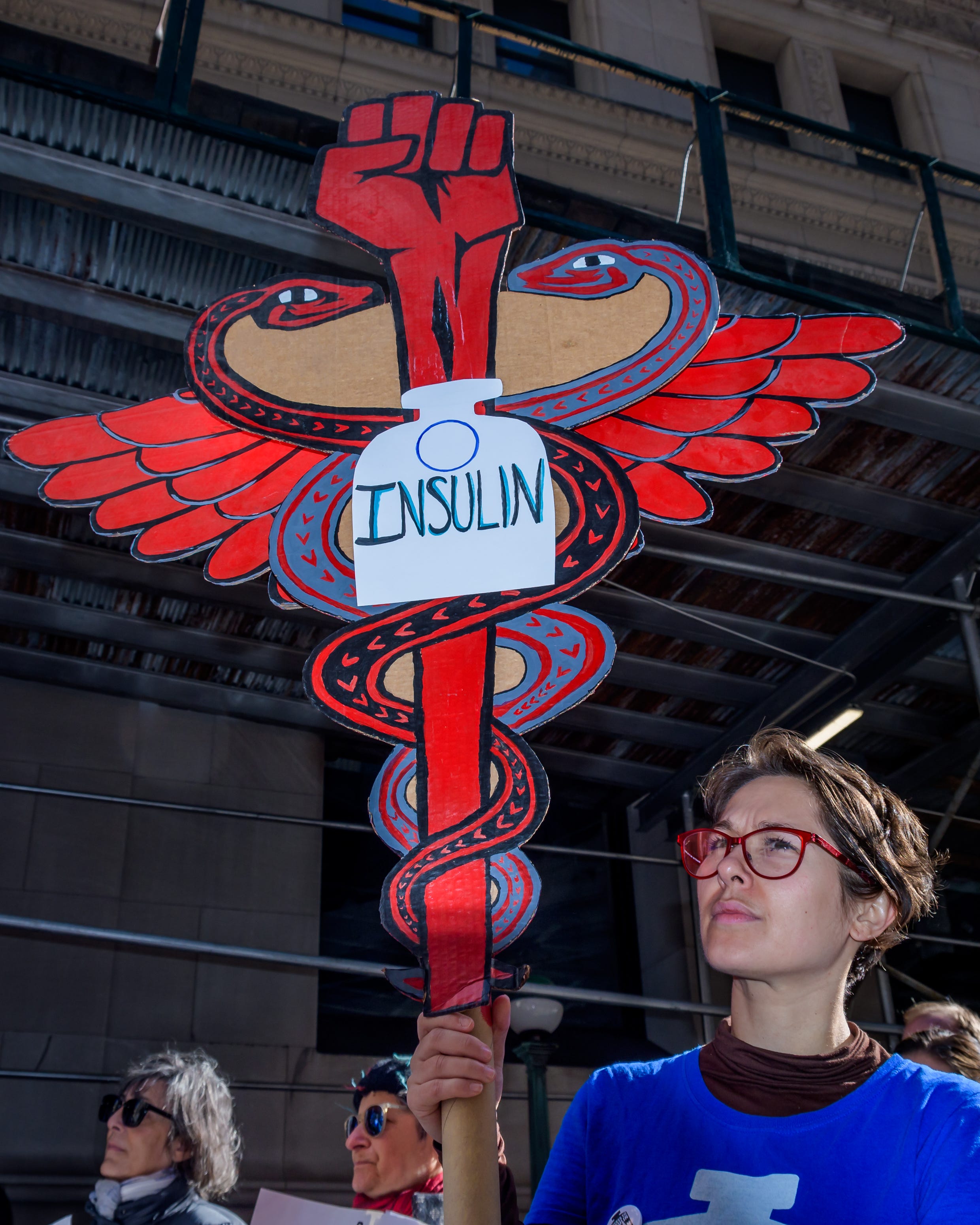 Participant holding a protest sign at a rally for affordable insulin for people with diabetes.