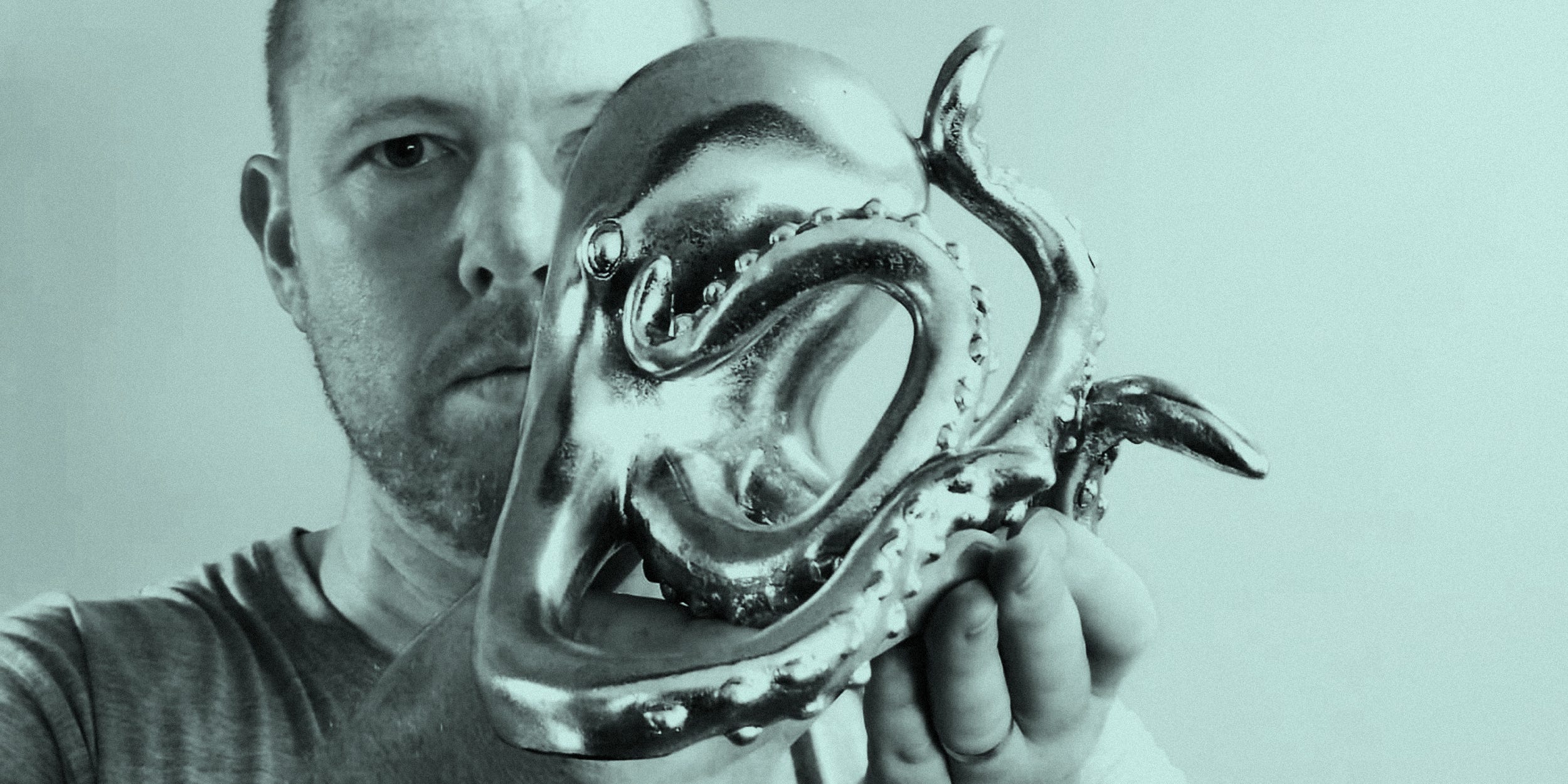 Tim Horan poses with an octopus statue for his latest podcast.