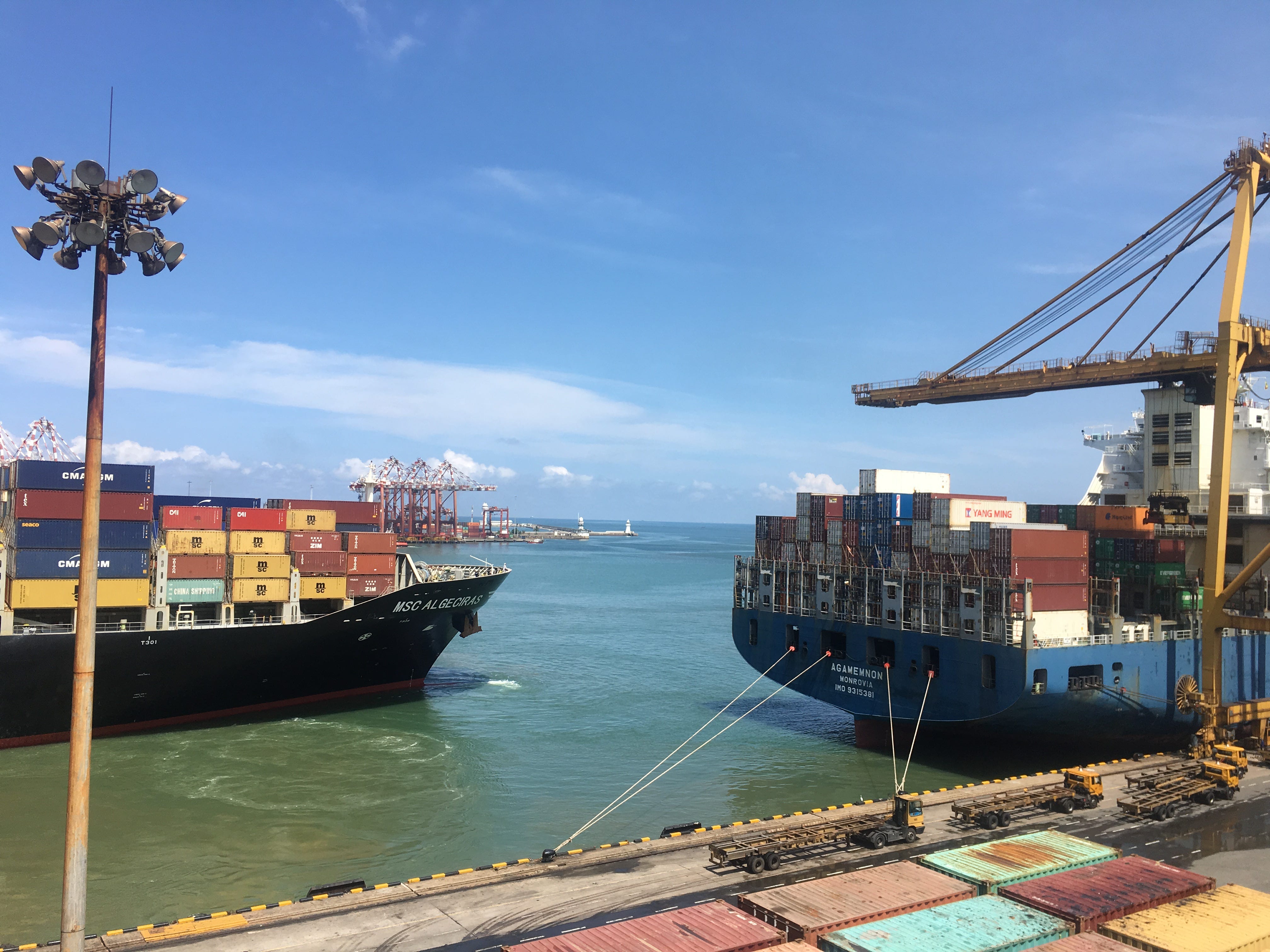 Cargo containers loaded on ships in front of a dock