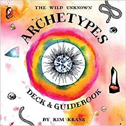 The Wild Known Archtypes deck and oracle book cover with pastel hues of pink and purple and items of divination around the page including crystals, skulls, candles, and a diamond.