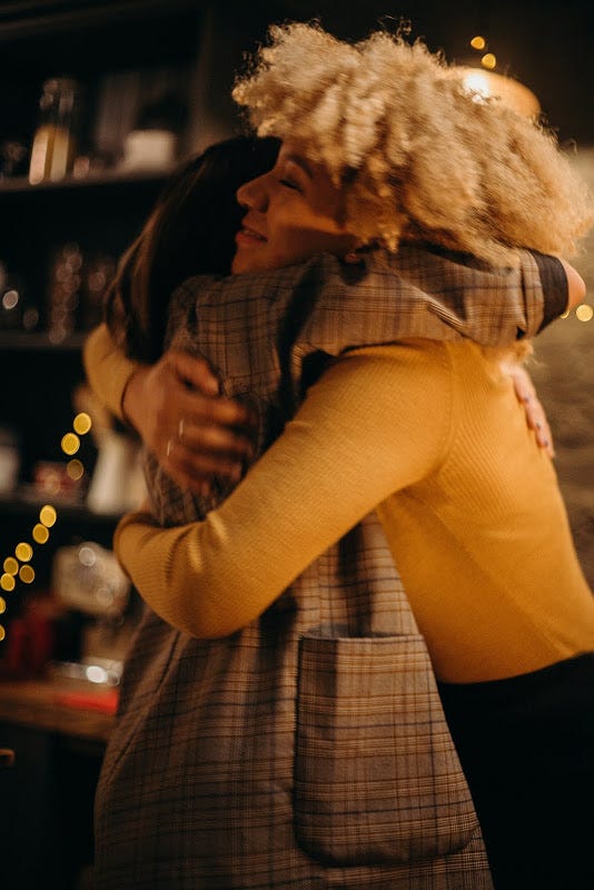 Two women embracing each other as a sign of gratitude.