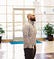 ADA Website Compliance Expert Kris Rivenburgh in checkered shirt and standing in business center lobby, looking up to right.