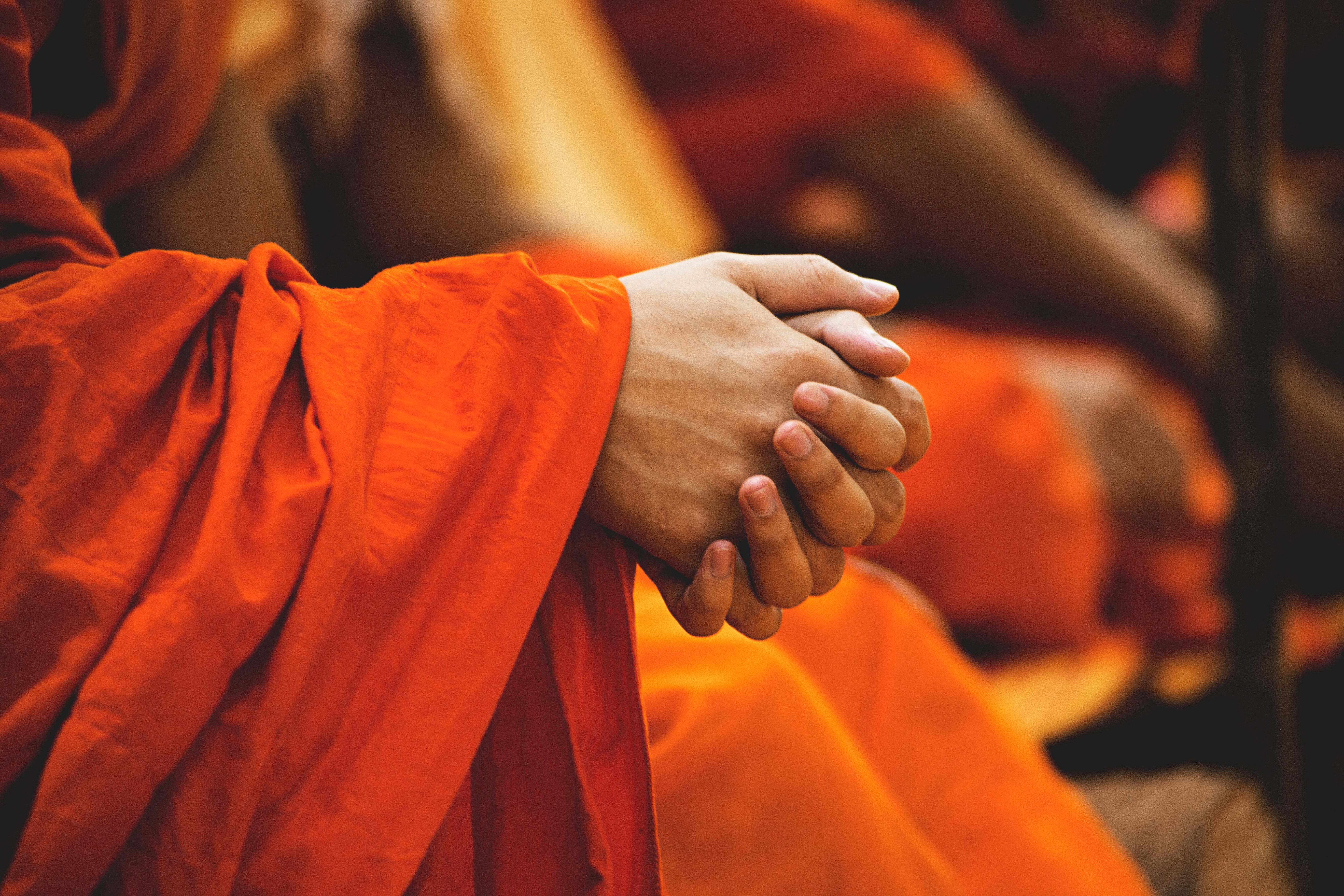 Buddhist sitting with hands crossed 