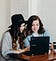 Two women looking at a computer