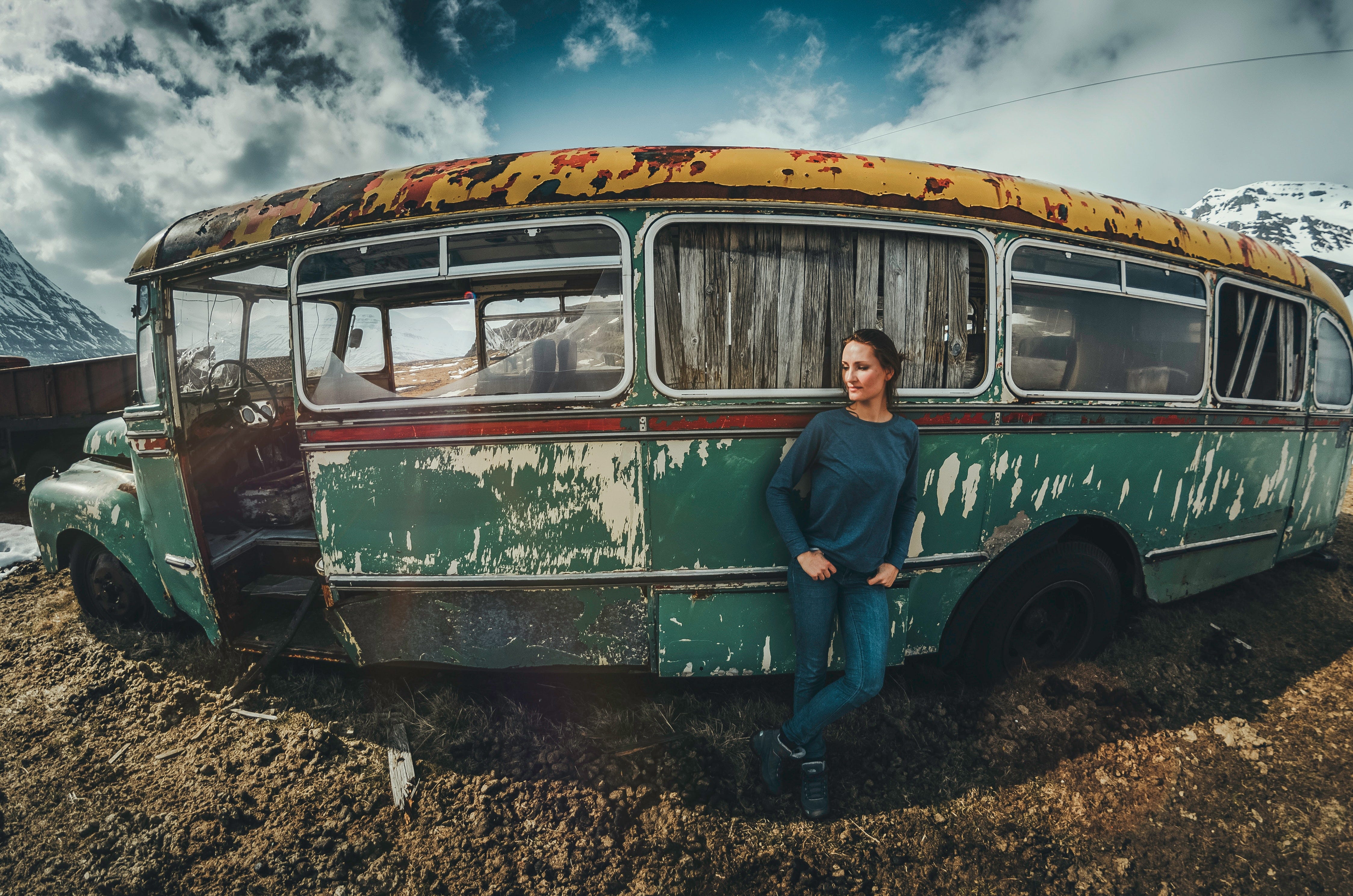 Woman standing in front of rusty van