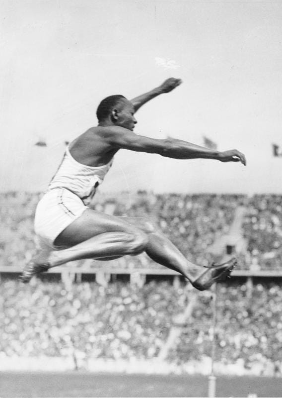 Jesse Owens with His Record-Setting Long Jump, Wearing Dasslers’ Shoes at the 1936 Berlin Olympics