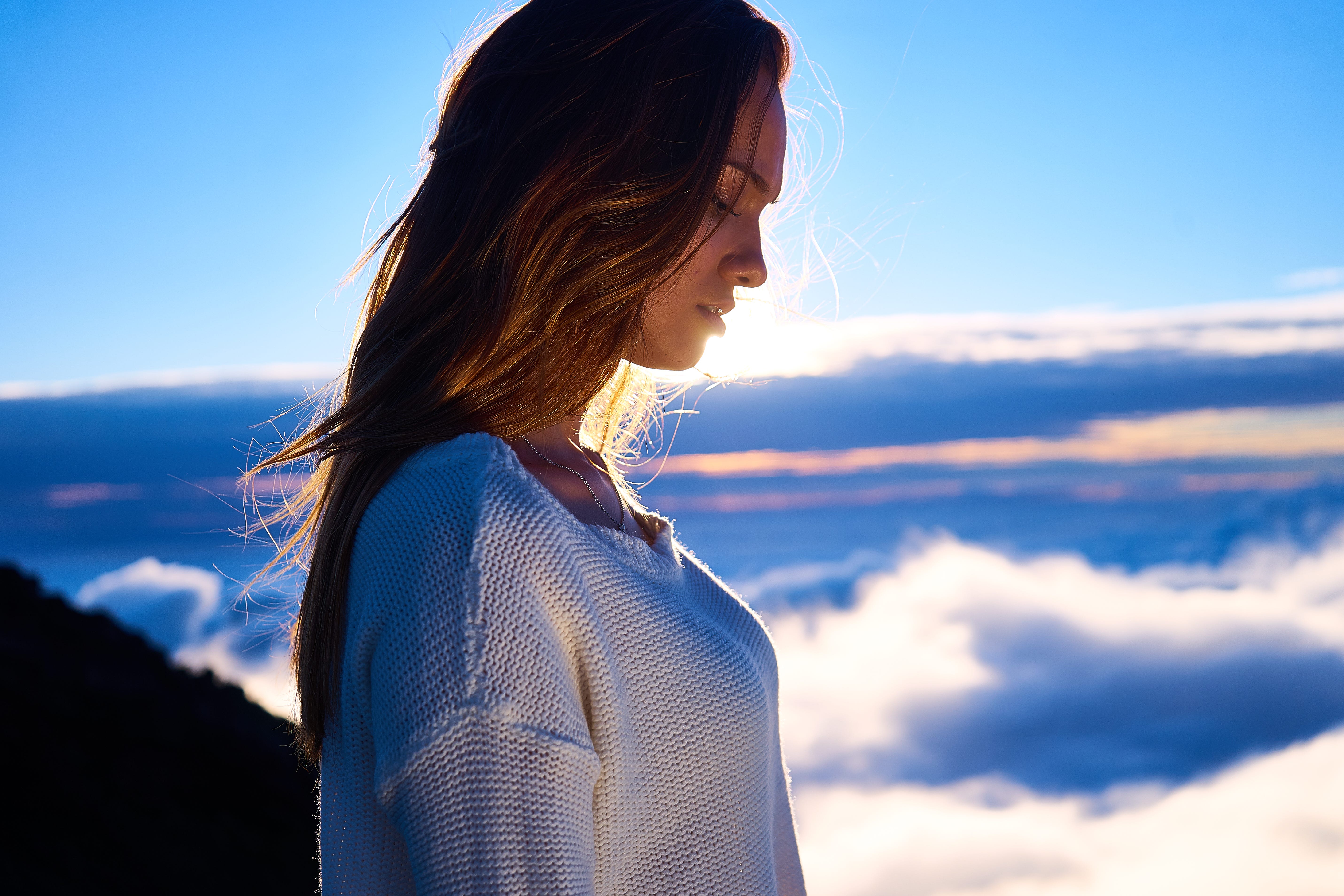 woman looking at clouds and wondering about getting into heaven