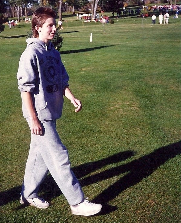 Gentry Bronson at the age of 14 in cross country running warm-up sweatpants and sweatshirt