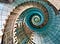 massive spiral staircase in beige and turquoise