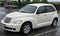 White 2001 PT Cruiser in a parking lot, the car was styled to look like older cars but produced in the 21st century