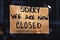 A hand-written sign in a store front saying we are now closed