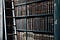 A ladder beside bookshelves filled with old-looking books