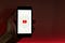 someone holding a youtube logo on their phone