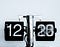 A flip-number clock with spinning numbers, black and white