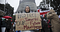 A woman holds a sign outside the Beehive at the Hands Off Our Tamariki rally: ‘Protect our tamariki, our future Māoritanga