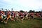 Luke Brenneman as a teen, center in red and black, running amongst many other teens, but very clearly smaller in stature.