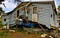 House knocked off foundation and laying on top of an upside down pickup truck after hurricane in Louisiana.