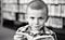 Photo of a small boy, reading.