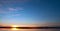 A cloudy sunrise over a large body of water