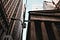 A stone bank with a streetlight that reads “Wall Street”