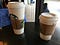 Small and large Starbucks coffees.