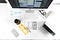 A bird’s-eye view of a desk with an iMac, a MacBookPro, and papers scattered across the table.