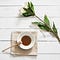 Honey in a bowl next to a white flower.