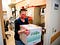 RN Courtney Senechal carries a refrigerated box of Moderna coronavirus vaccines for use at the East Boston Neighborhood Health Center on December 24.
