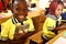 A boy in class holding an English textbook- Cameroon