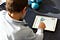 Boy operating a tablet.