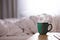 Bedside table with coffee cup.