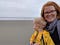 Image of Jordan on the beach in Oregon, with her daughter, who is turned away from the camera, looking out at the ocean