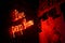 red neon sign reading “live peep show”