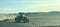 A tractor driving along a field.