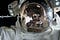 Astronaut helmet reflecting space station.