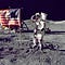 Moonshot Thinking: America Puts a Man on the Moon. He is saluting next to an American Flag.