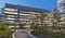 8 story office building complex with green space in the center.