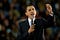 President Obama holds up microphone while delivering remarks to crowd.