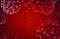 Coronavirus molecules floating in a red medium