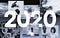 Collage of DNA, SpaceX launch, a scientist drawing up a syringe, the Covid molecule, and a woman scientist + the text “2020"