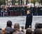 Emmanuel Macron standing in rain