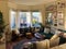 A cozy living room with large bay windows.