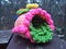 A crochet sugar egg with crochet flowers, trim, and grass