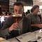 Gregory Harris sipping a humongous beer.