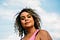 A closeup photo of Adrienne Maree Brown against the sky.