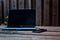 Macbook and Iphone on a worn wooden picnic table